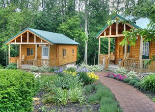 the two cabins from the outside with flowers in bloom